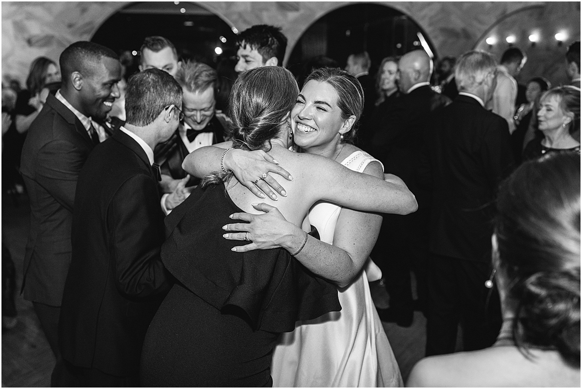 bride hugs friend at wedding