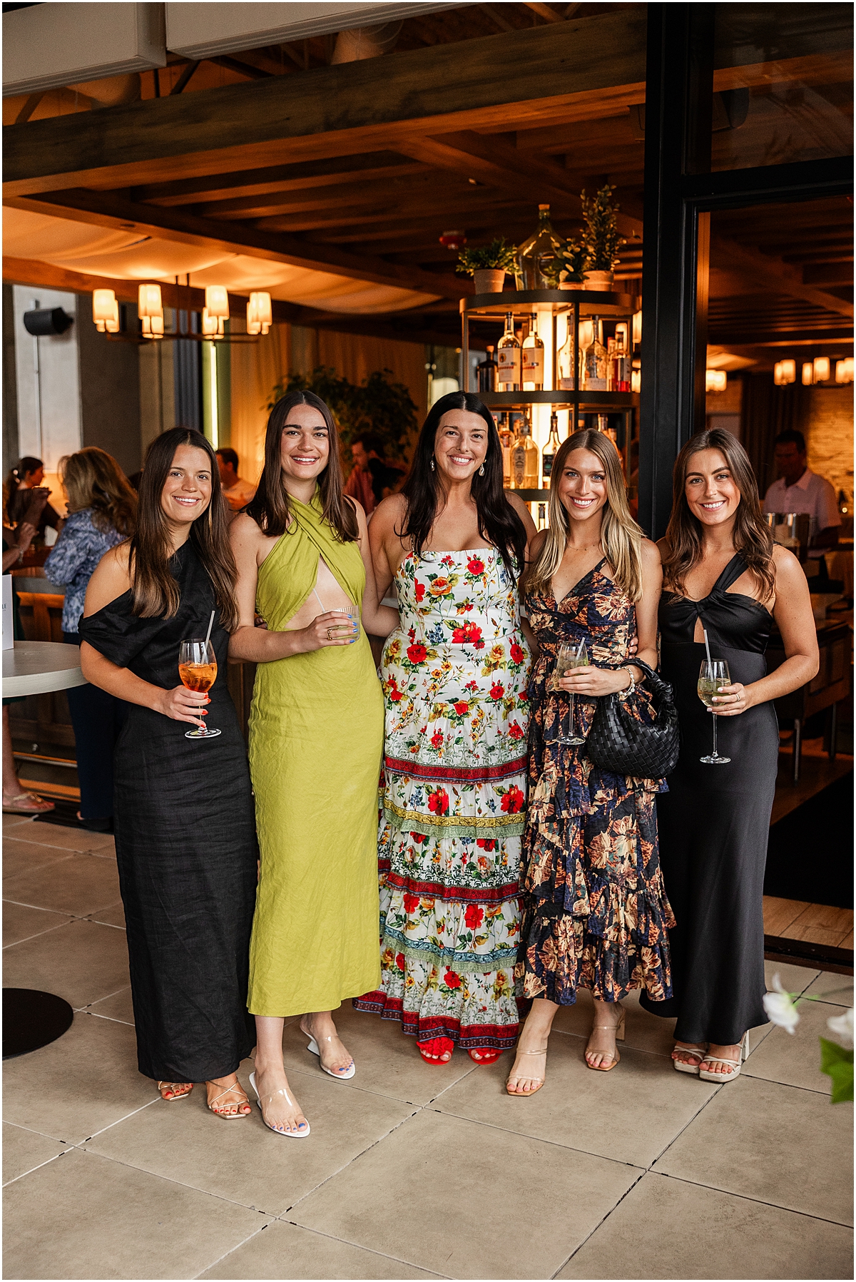 bride to be with women in stylish dresses