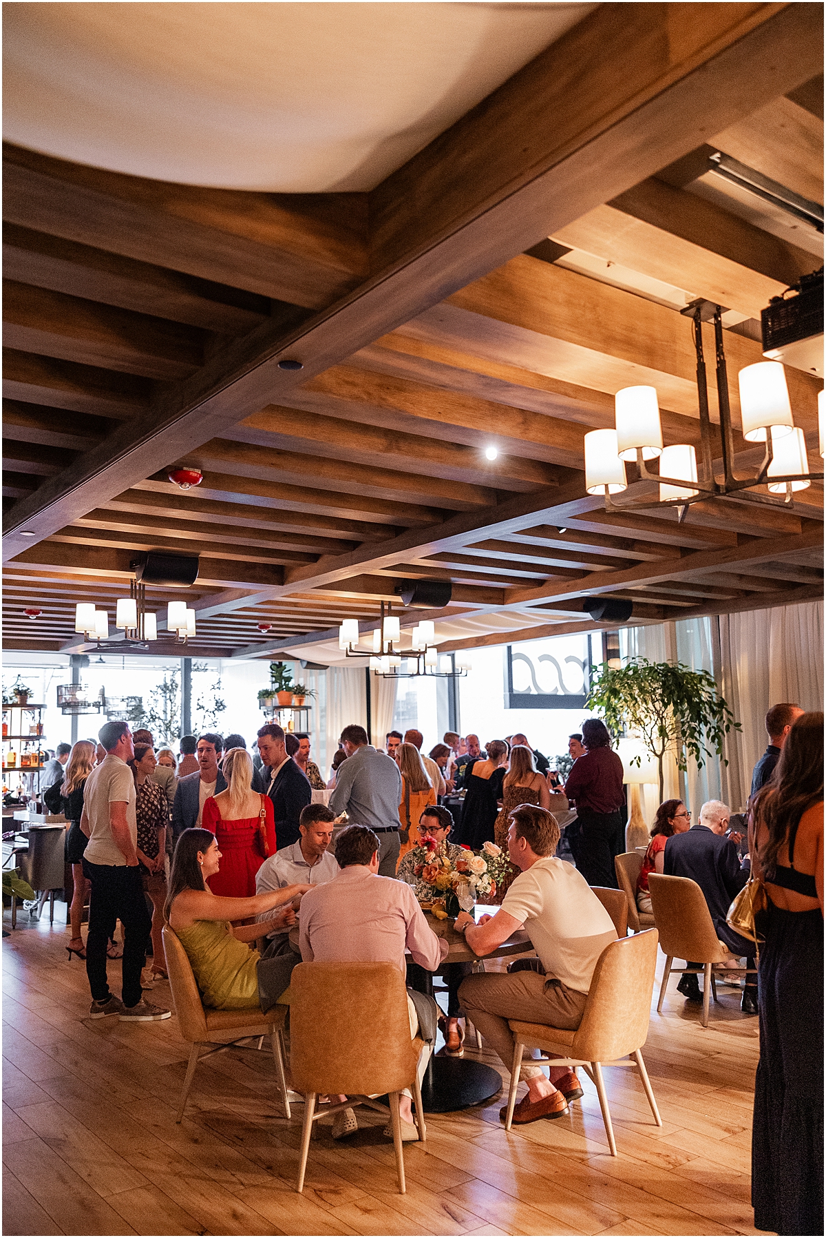 guests sit at dinner welcome party night before chicago wedding