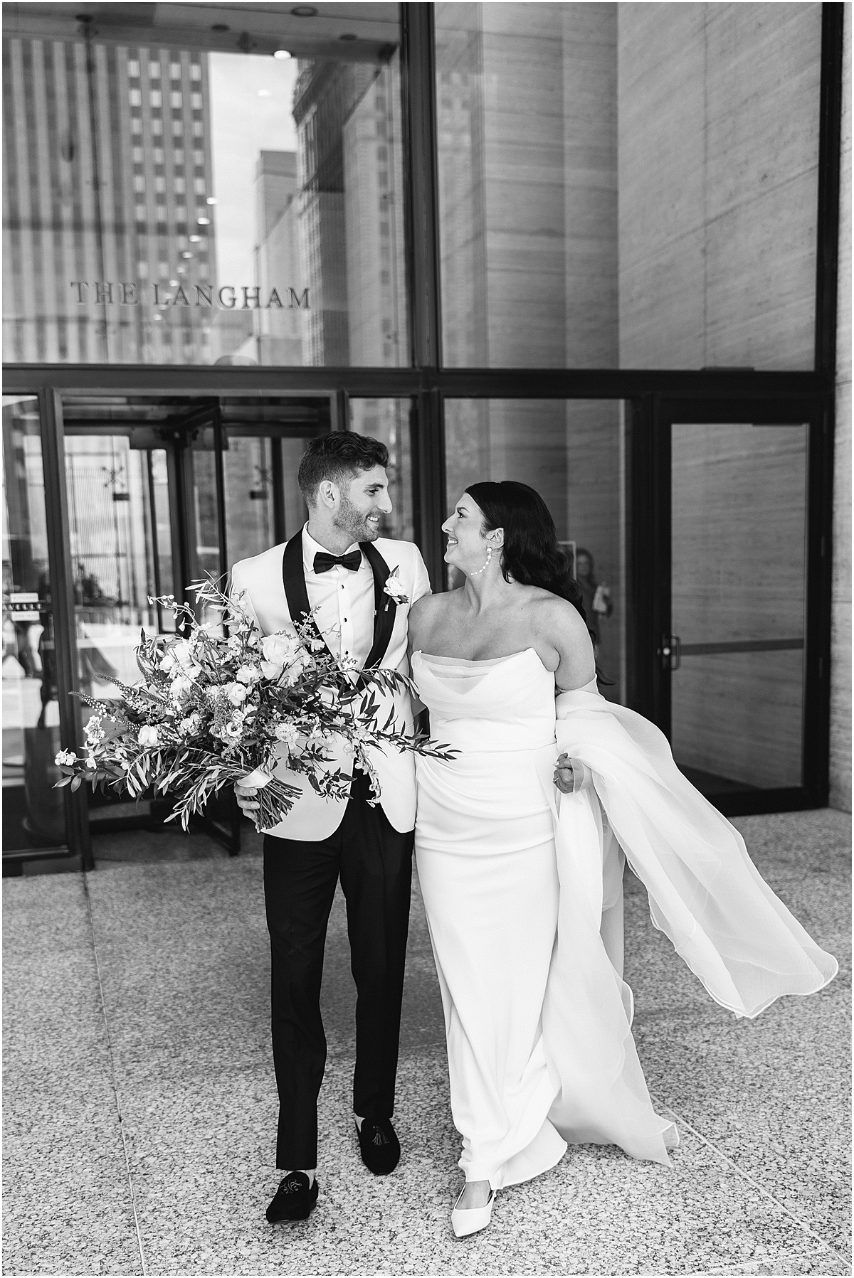 bride and groom walk out of The Langham in Chicago