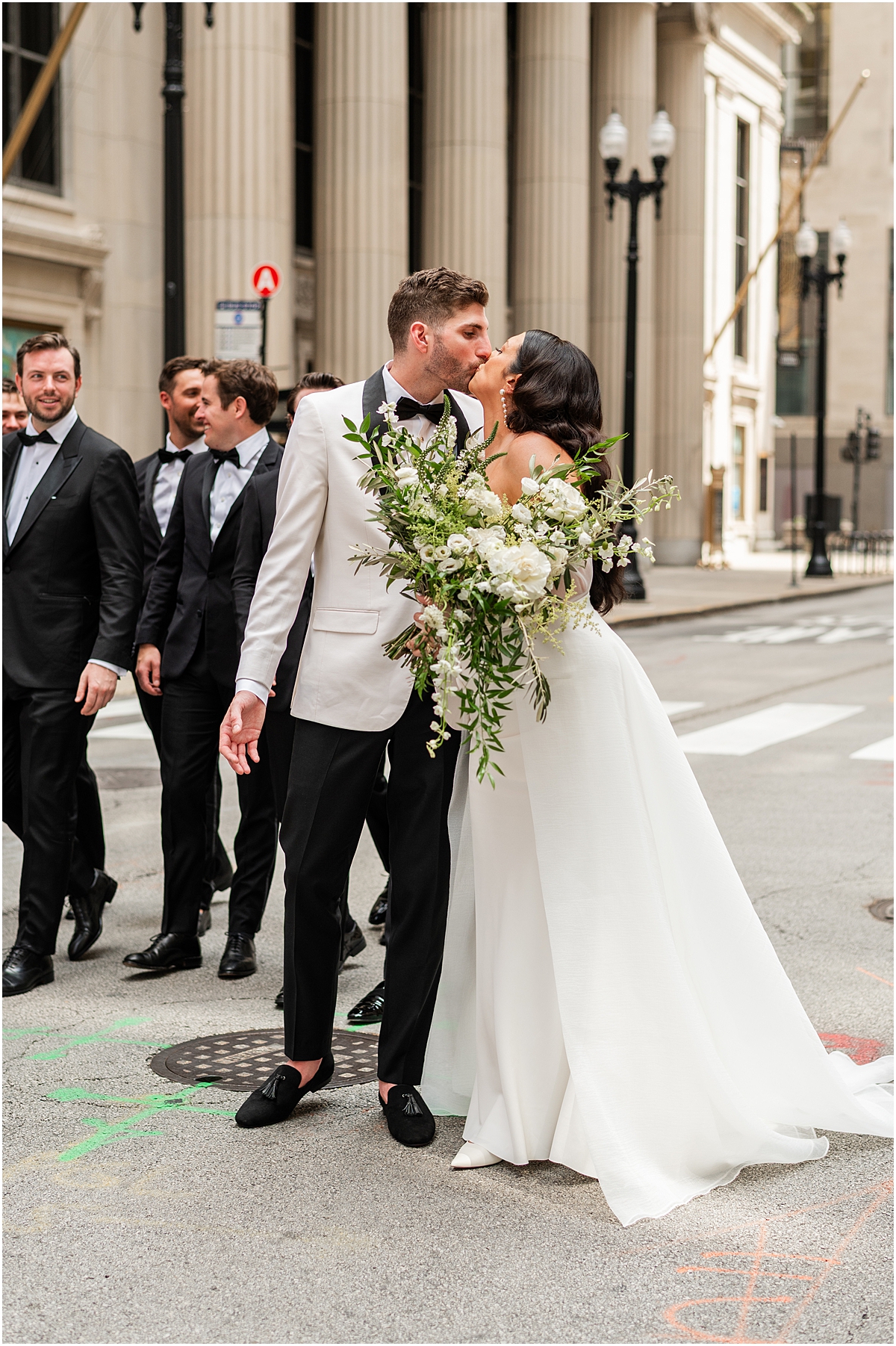 bride and groom kiss in Chicago street