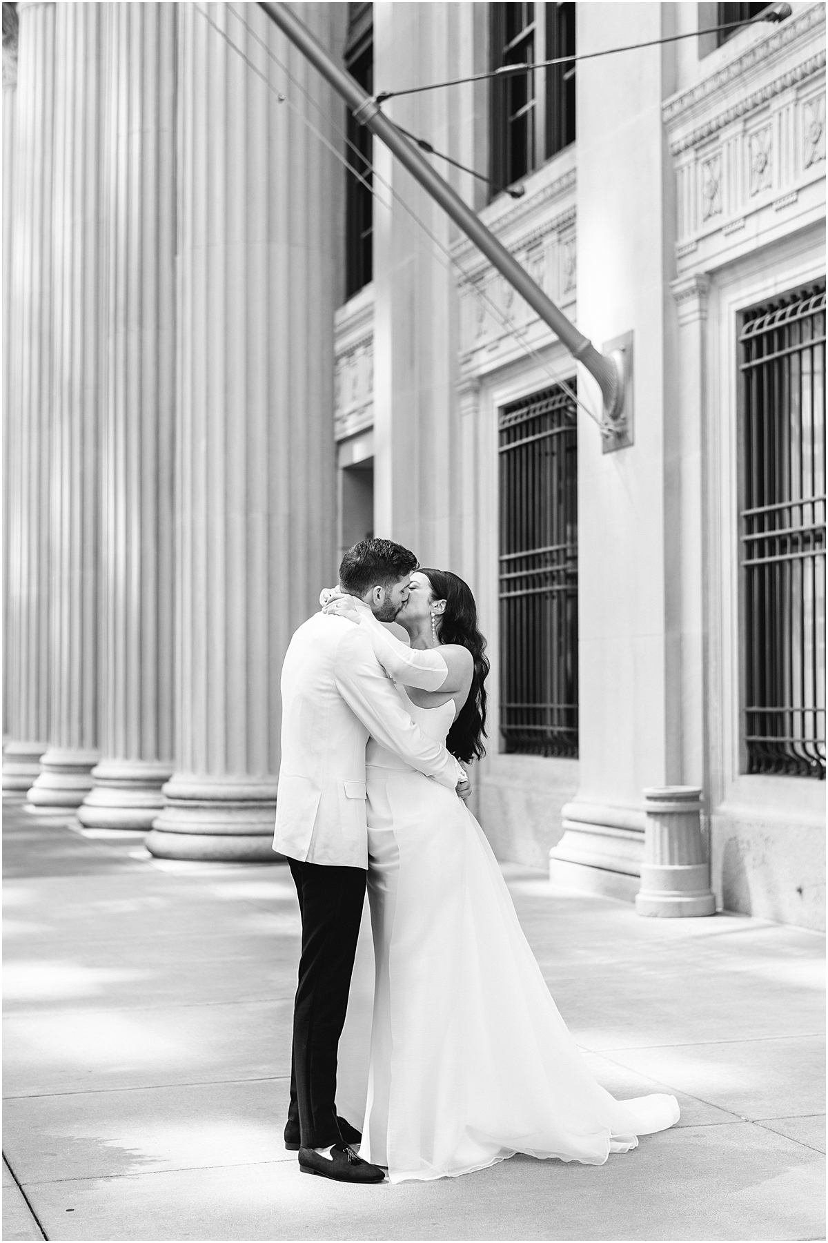 romantic photo of bride and groom kissing outside building in Chicago
