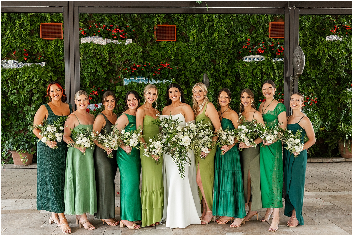 bride and bridesmaids in different shades of green dresses