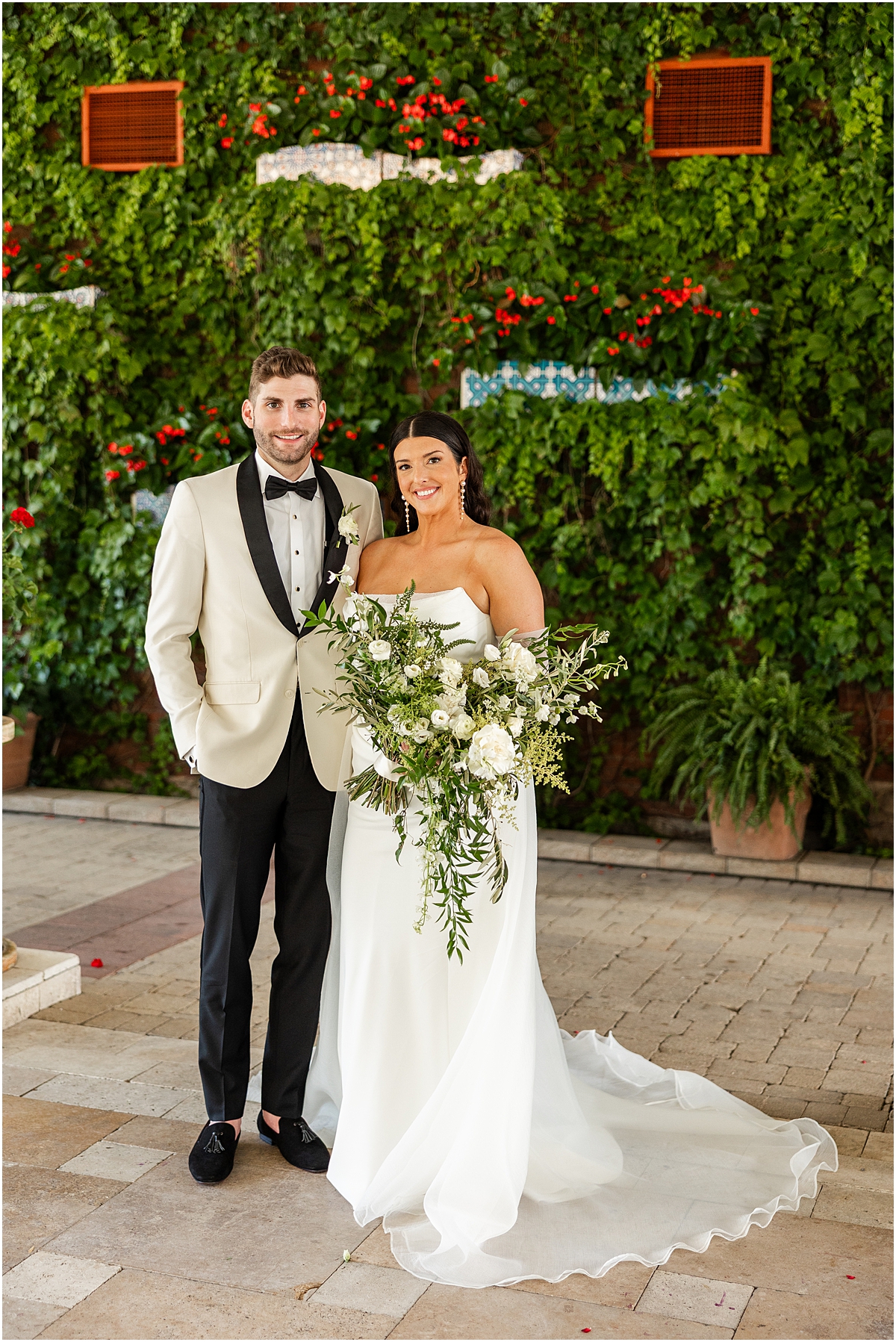 bride and groom portraits in front of garden wall at Galleria Marchetti in Chicago