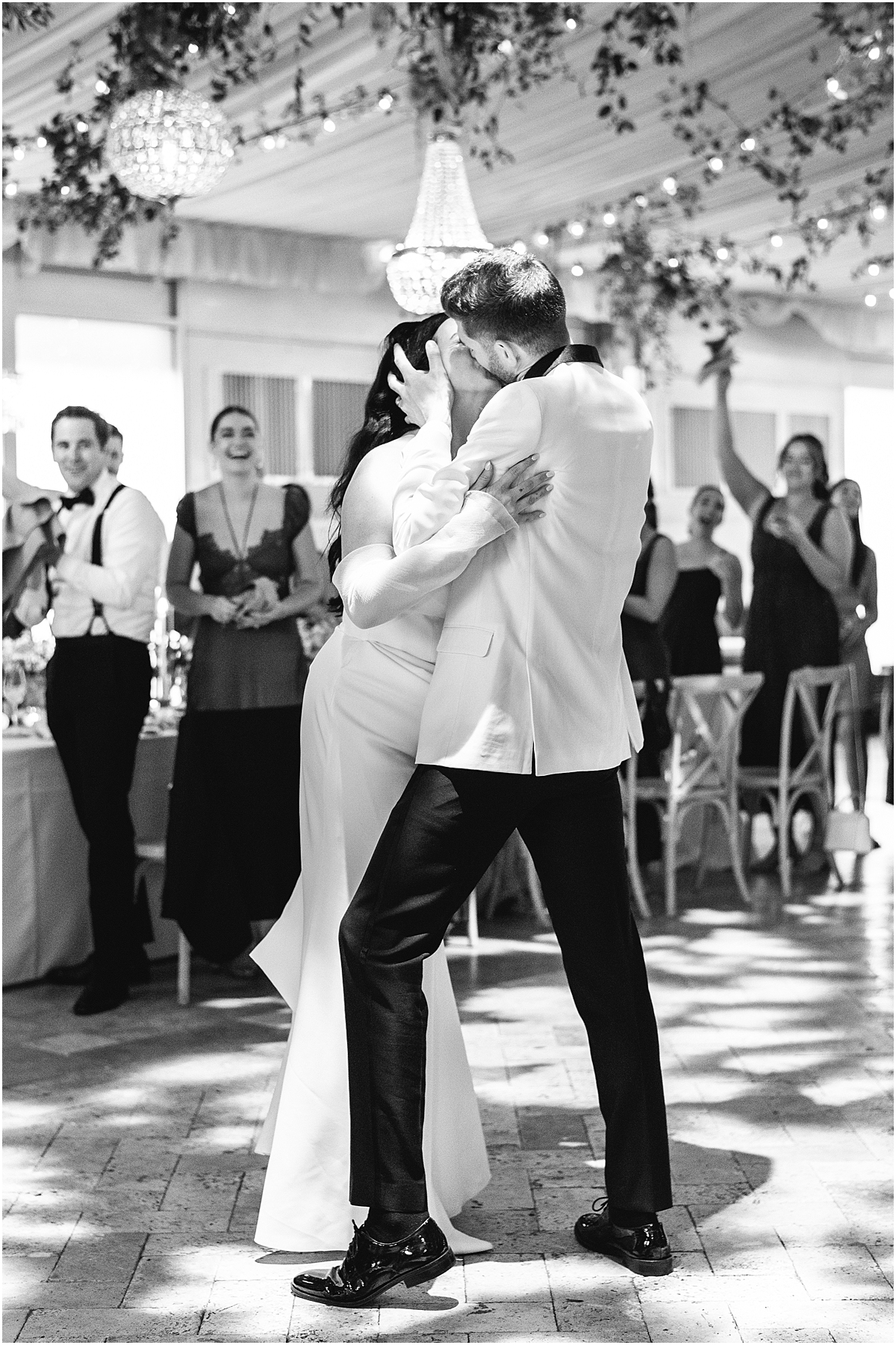 groom kisses bride on the dance floor