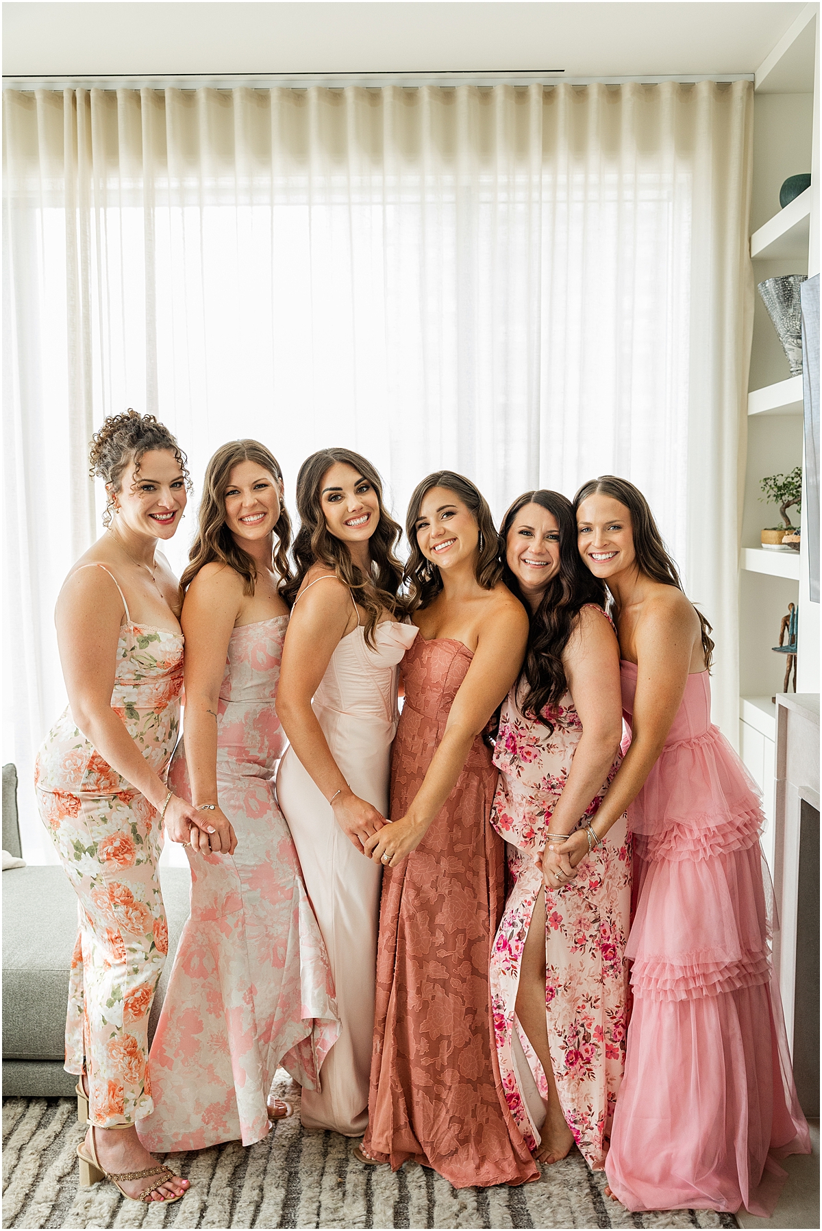 bridesmaids in pink dresses in various styles and patterns