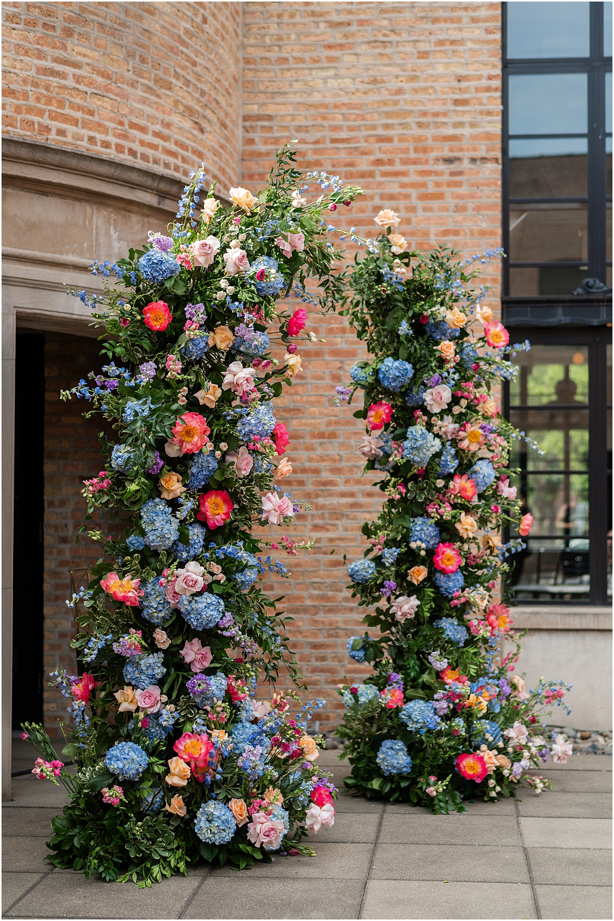 Colorful floral Wedding arch at Revel Motor Row ceremony in Chicago