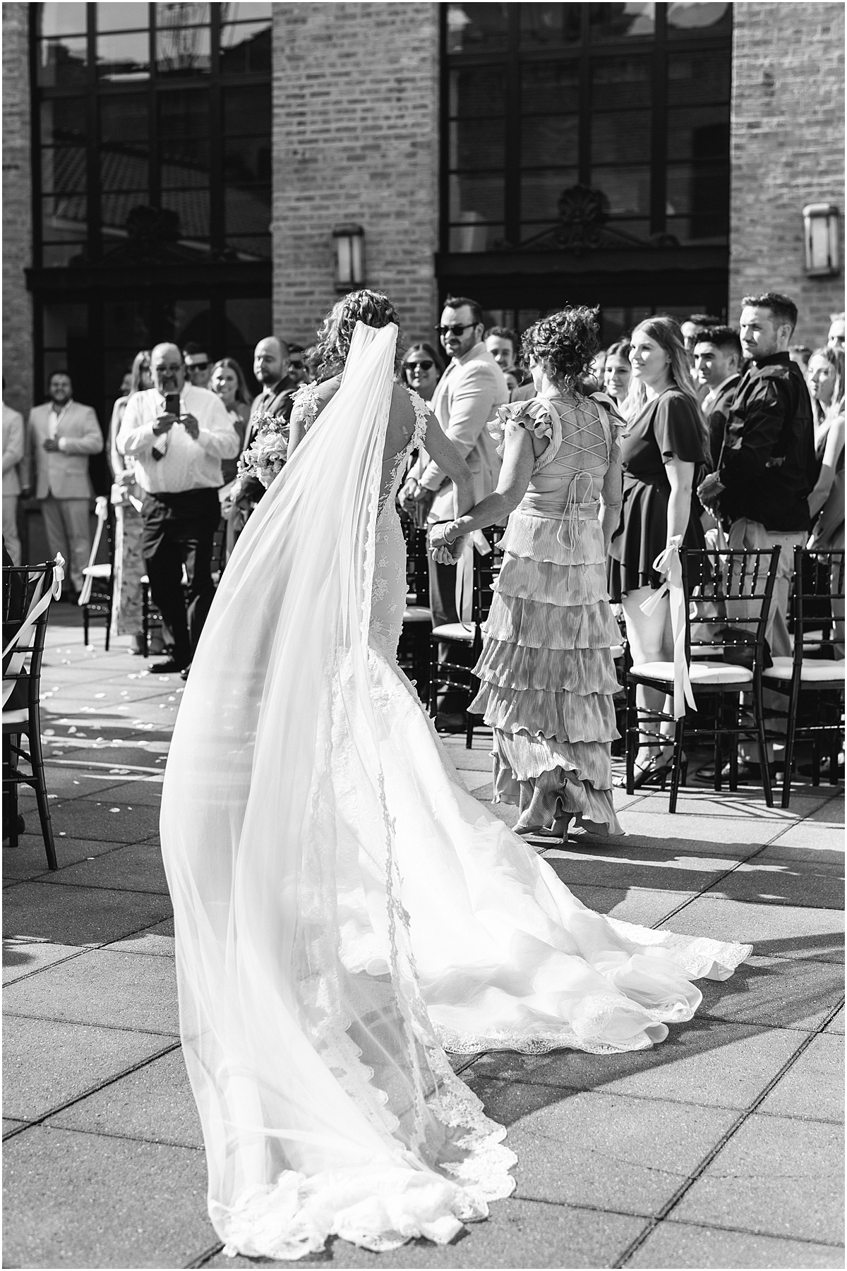 bride walking down the aisle with mom