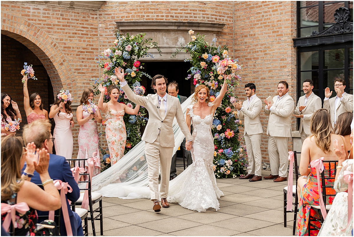 newlyweds exit wedding ceremony at Revel Motor Row