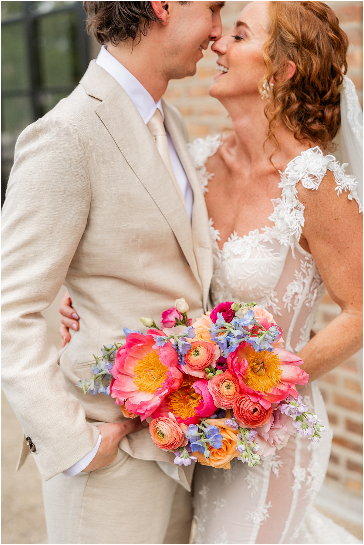 candid newlywed photos with bride holding colorful bouquet