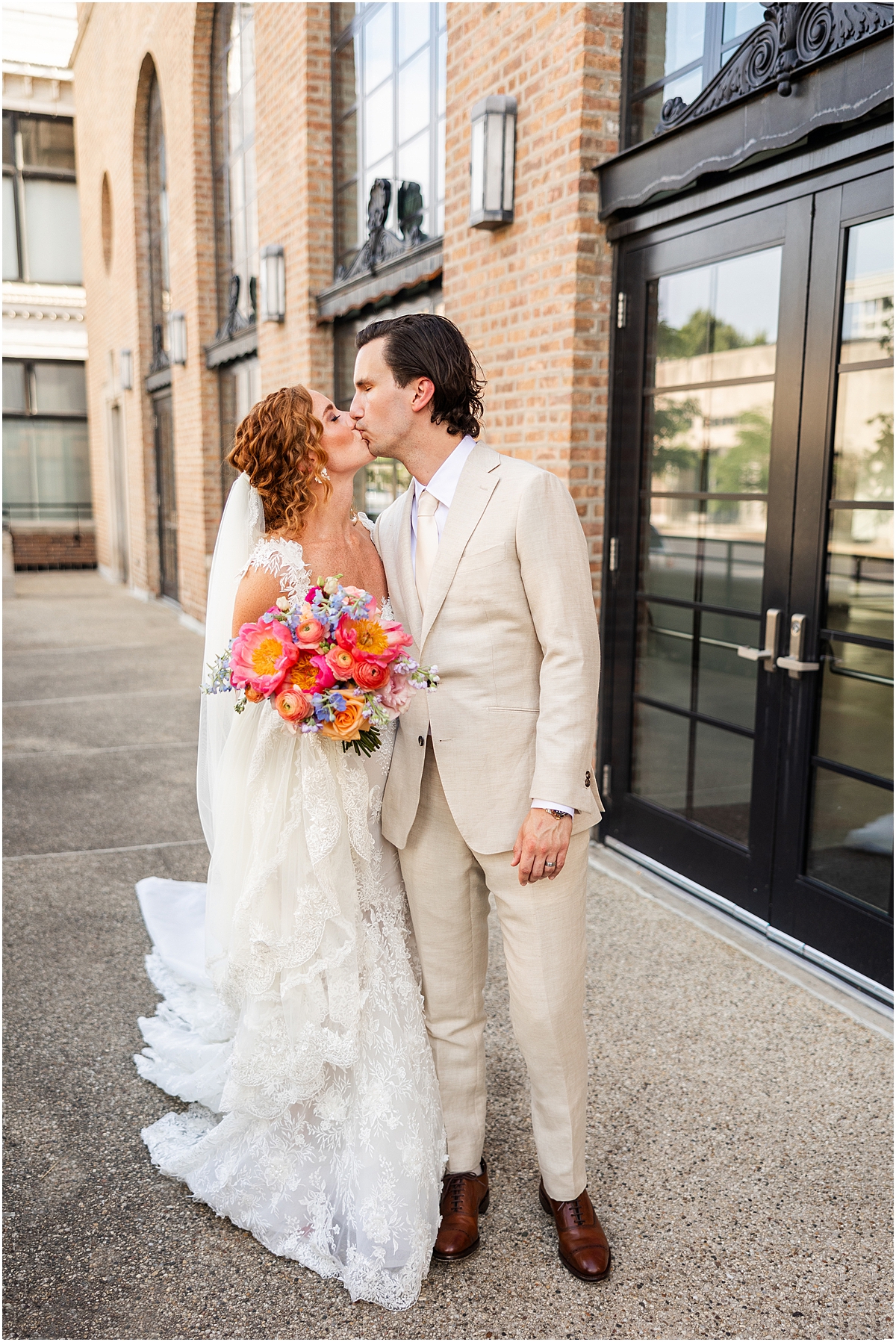 newlyweds kiss outside of building in Chicago