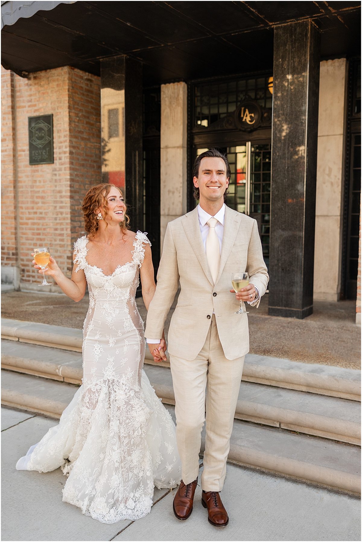 newlyweds hold drinks