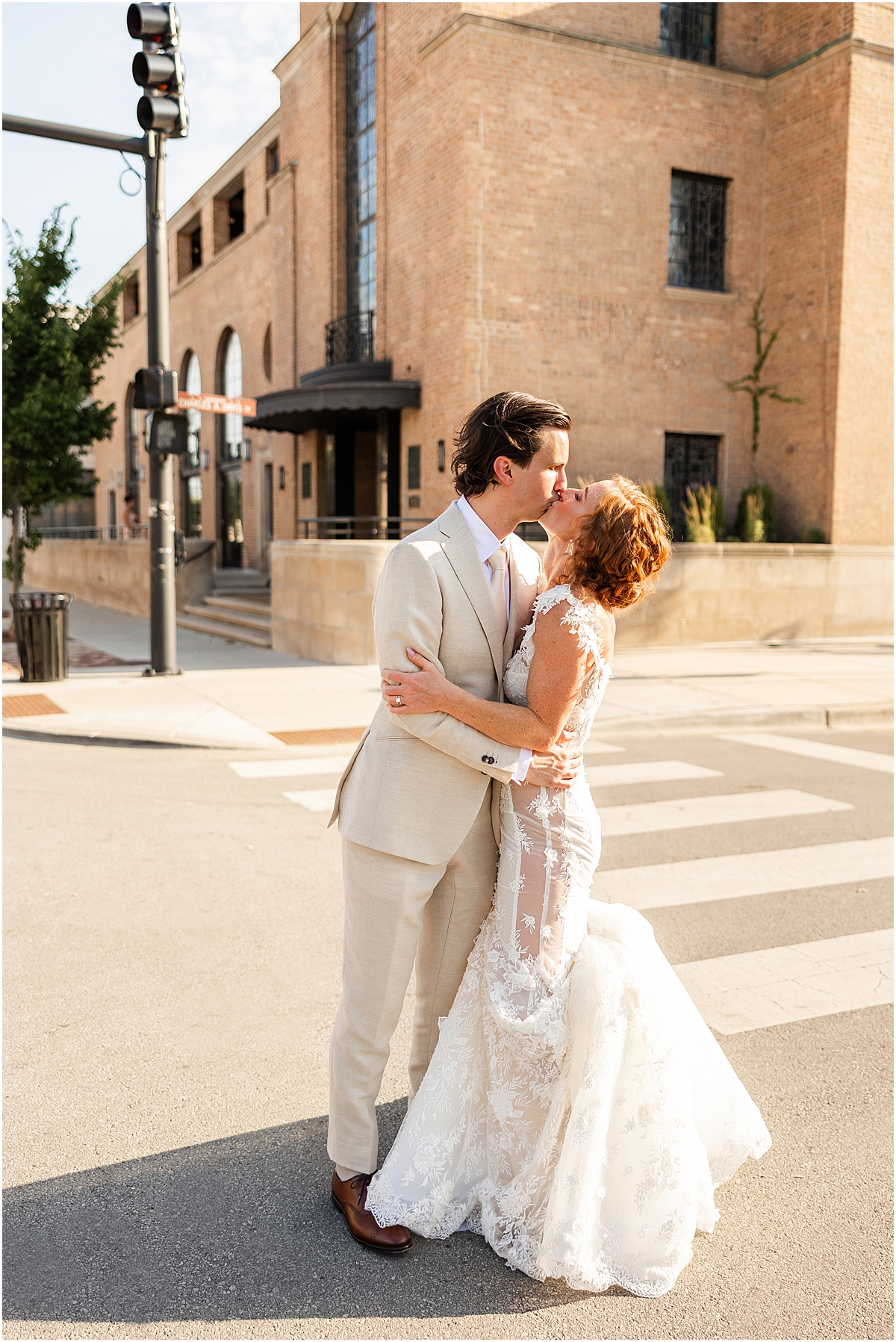 romantic wedding photos of newlyweds kiss ing in street in downtown Chicago
