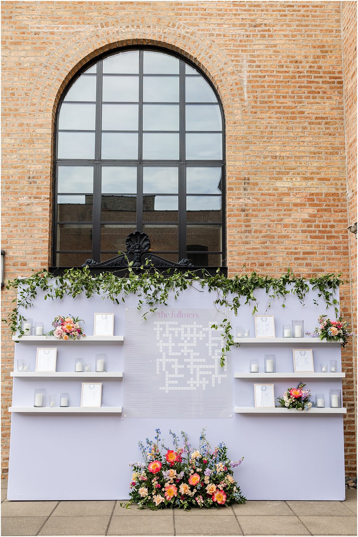 light purple seating chart display with personalized crossword puzzle in the middle from Summer Wedding at Revel Motor Row