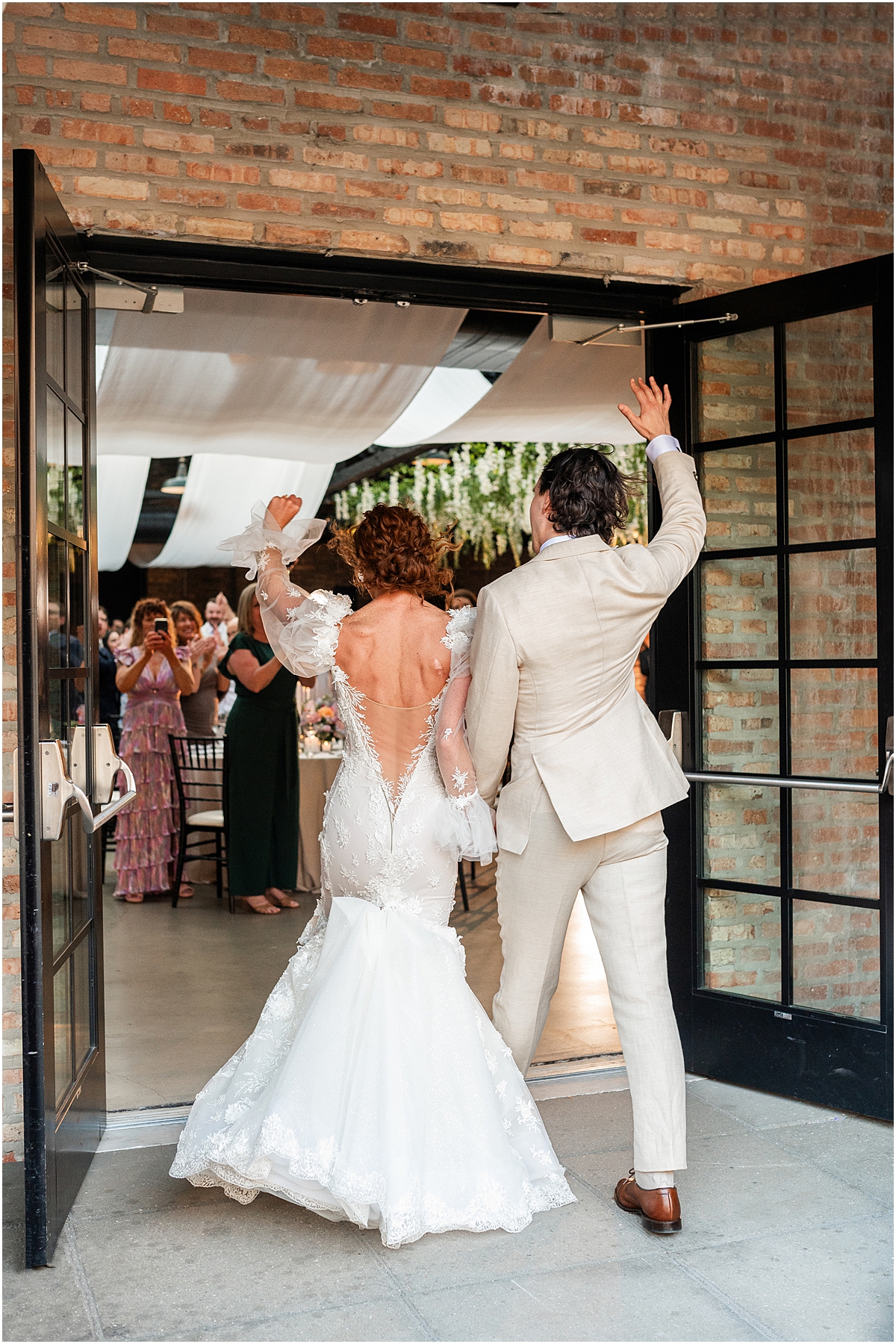 newlyweds enter wedding reception at Revel Motor Row in Chicago