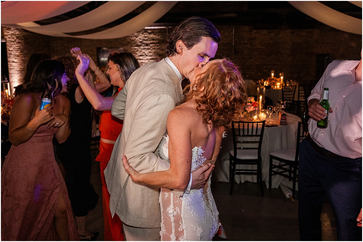 bride and groom kiss on the dance floor
