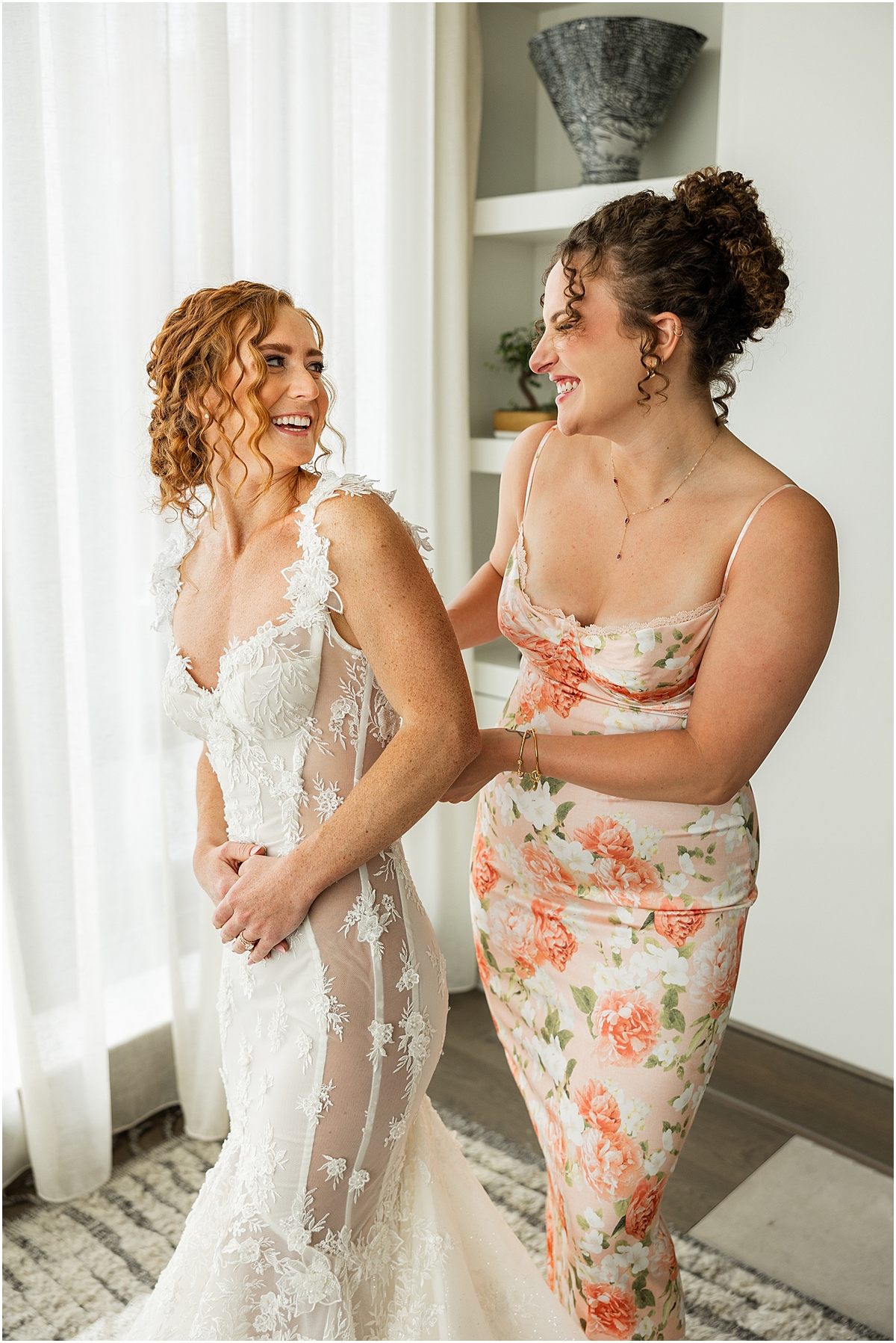 bride getting into wedding dress before Summer Wedding at Revel Motor Row