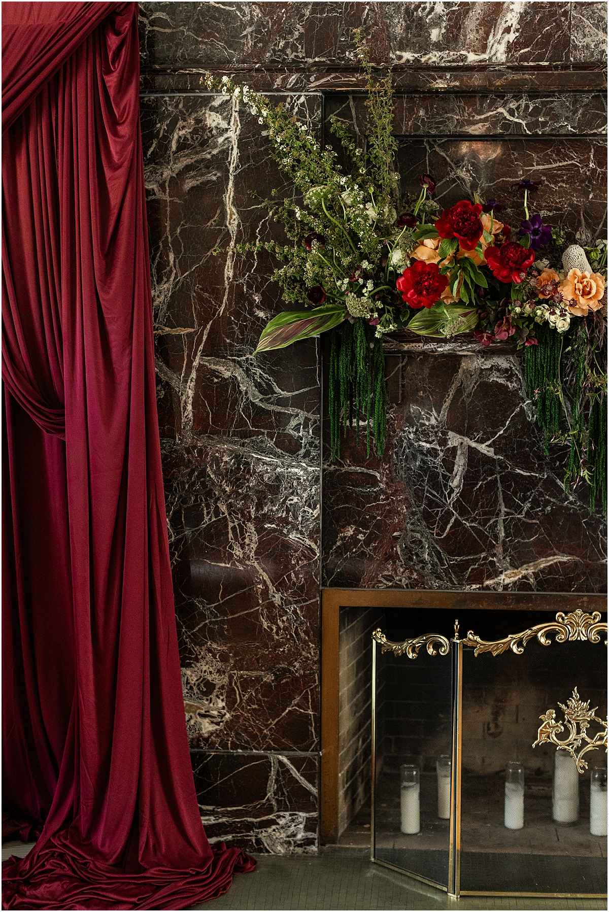 marble fireplace with drapery and flowers