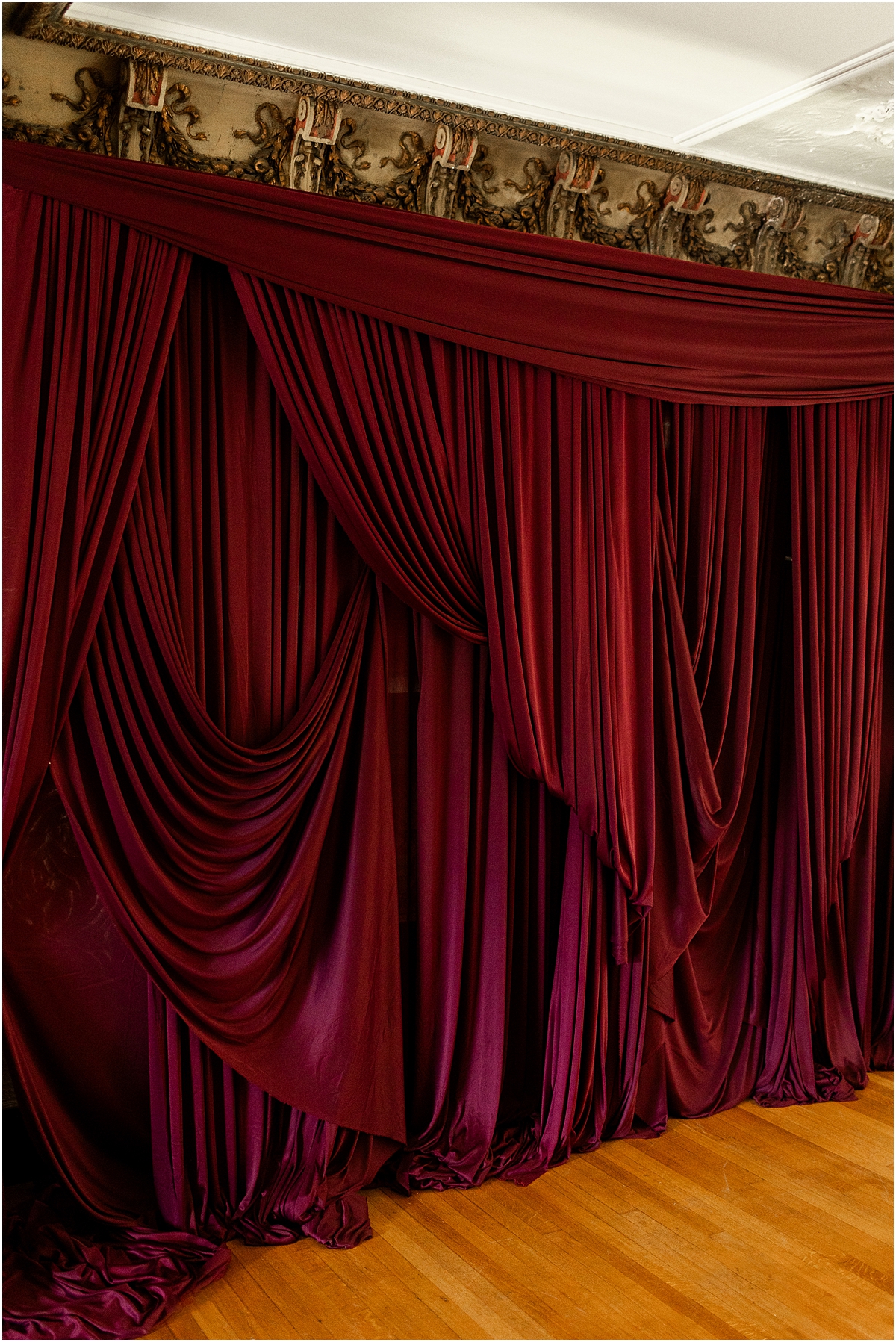 dark red drapery adds to the moody maximalist wedding editorial design