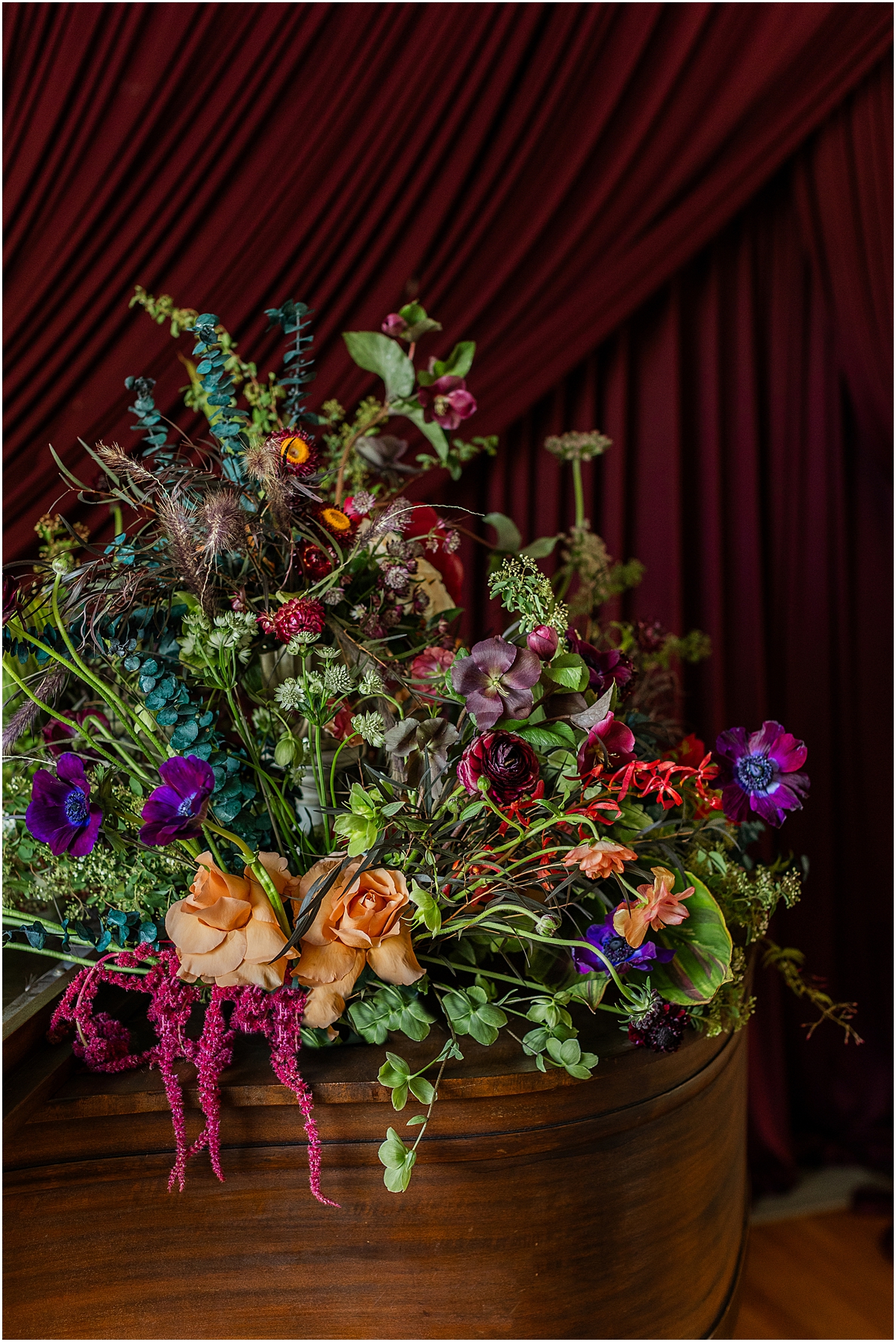 wedding flower arrangement with darker florals and textures