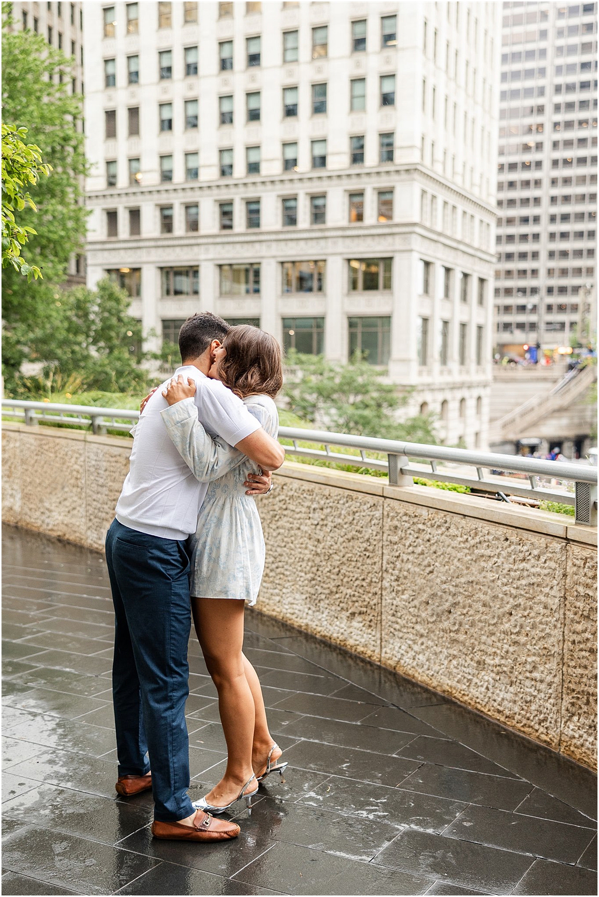 couple kiss in downtown Chicago during engagement