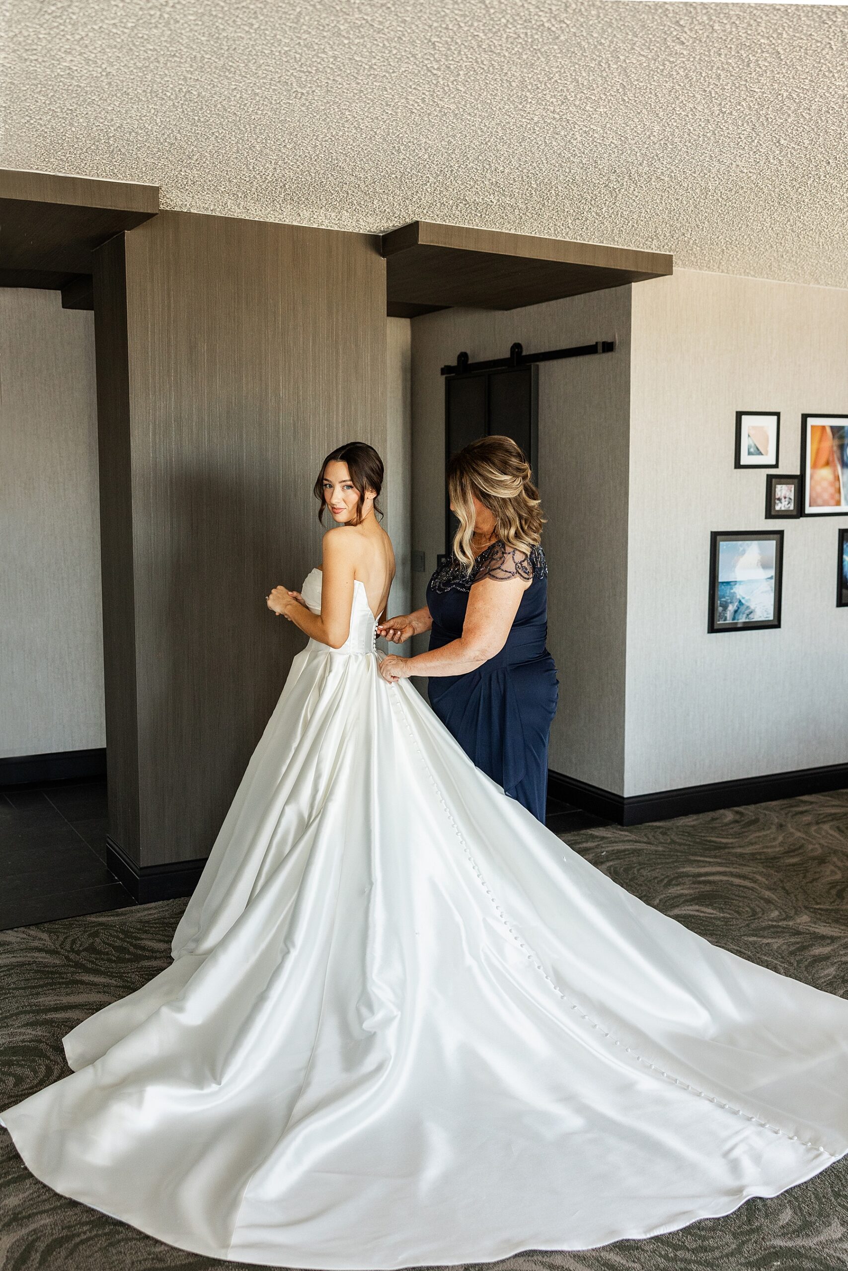 bride getting into wedding dress