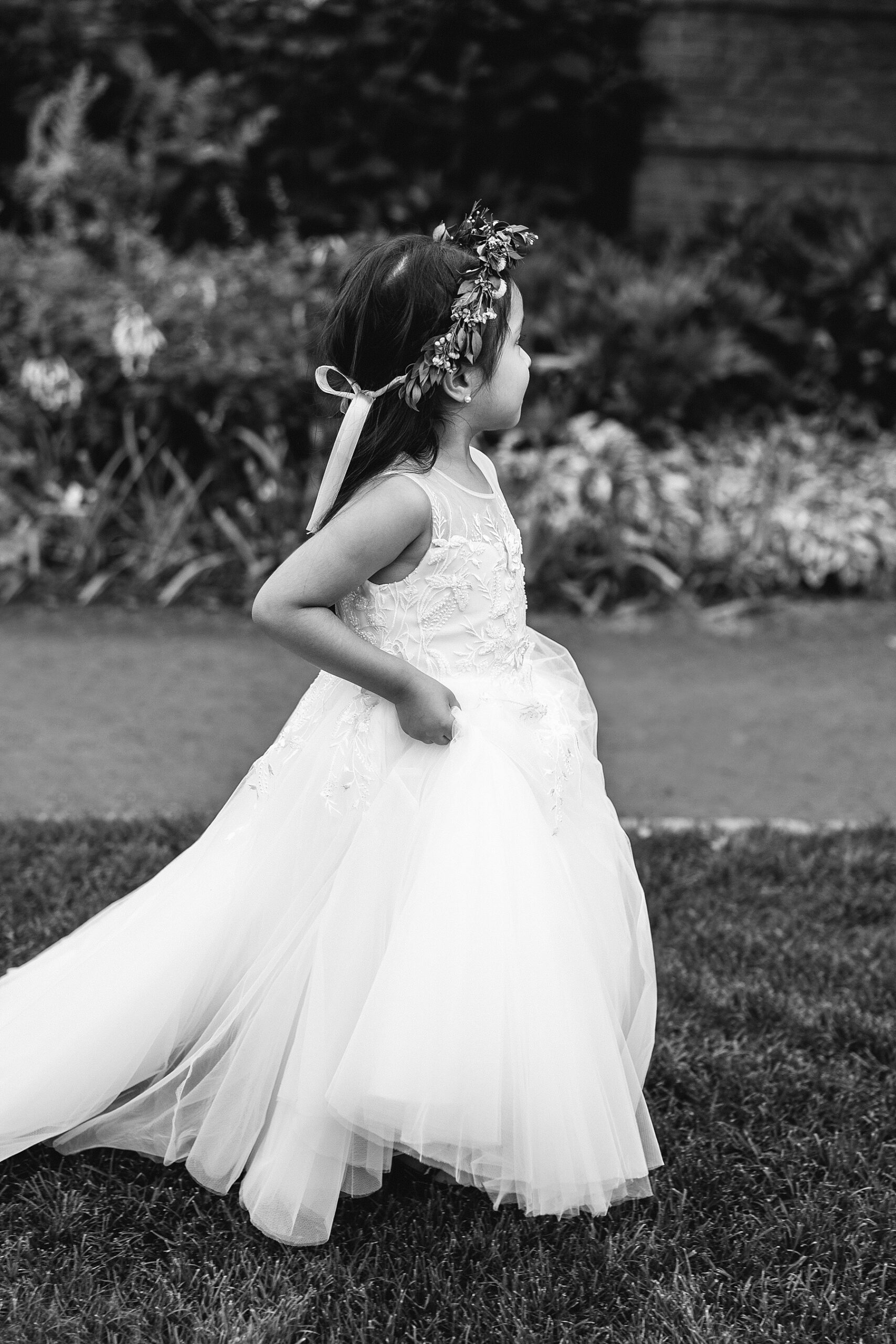 flower girl walking across lawn