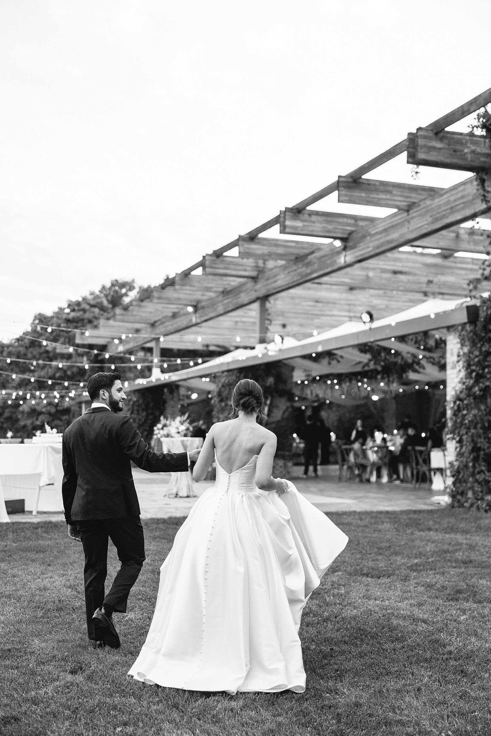 newlyweds walk to wedding reception. 