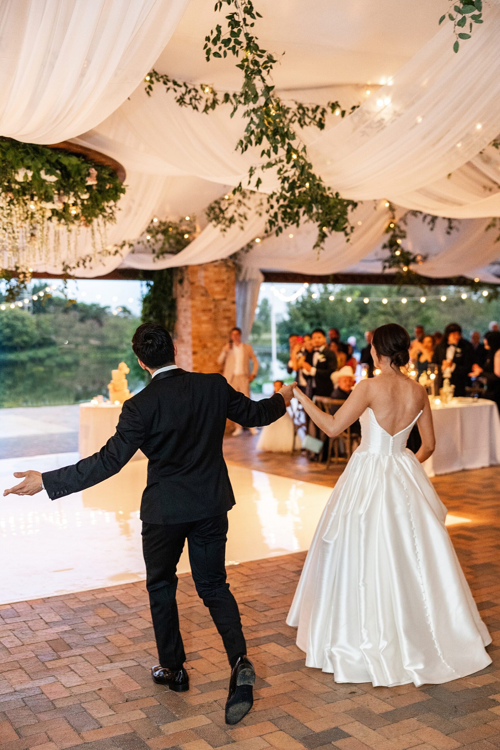 newlyweds make their grand entrance to wedding reception 