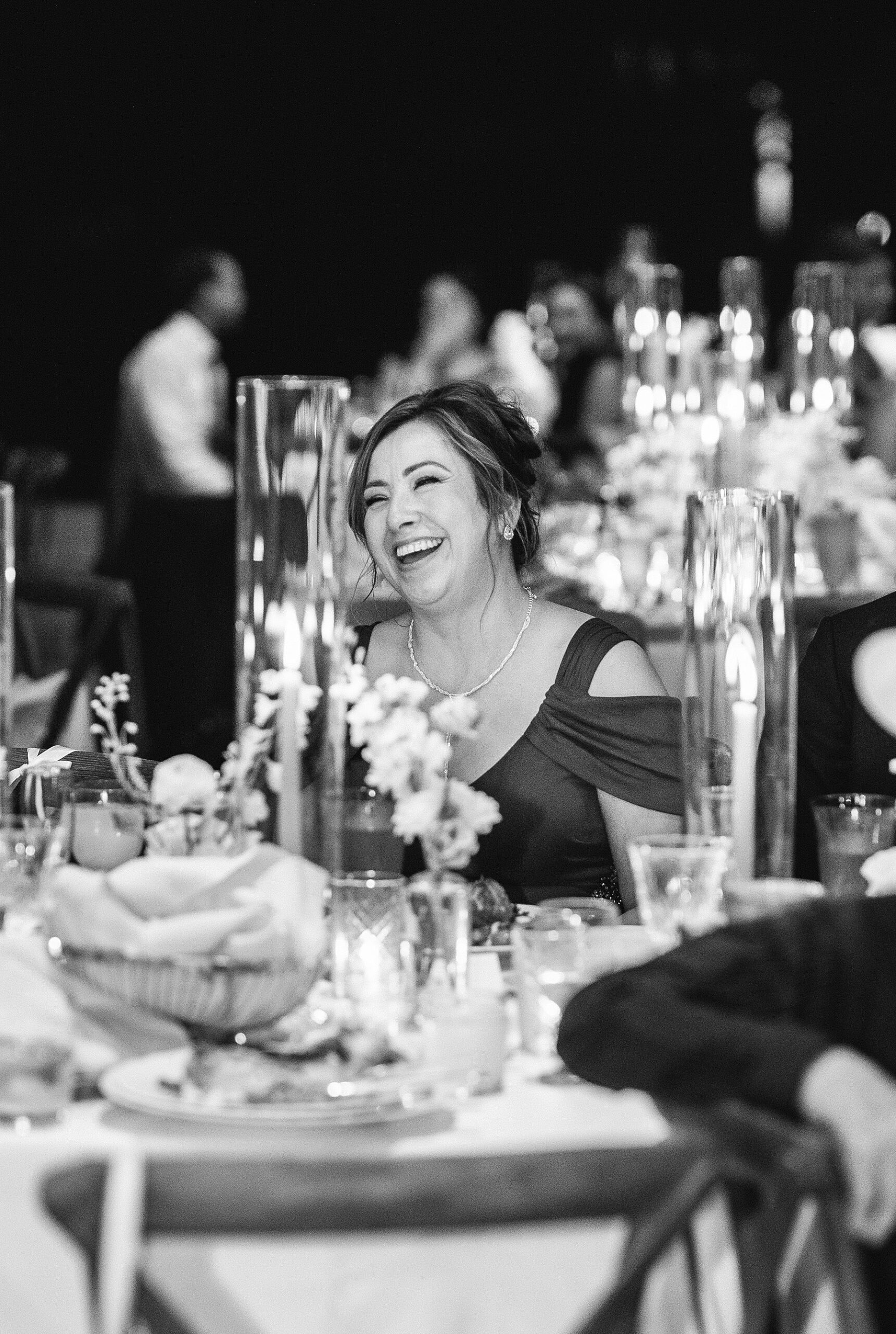 candid photo of guest laughing at table