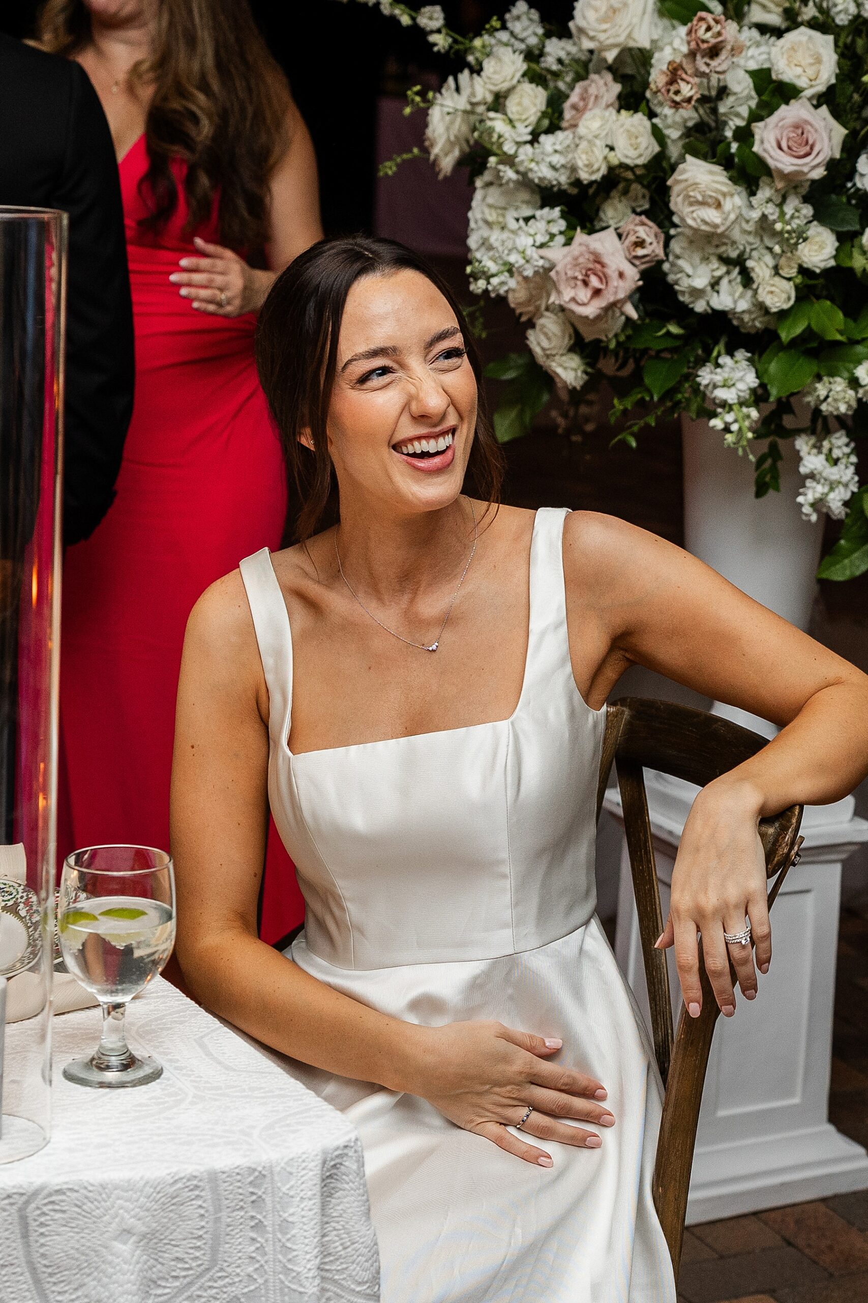 candid photo of bride laughing at table