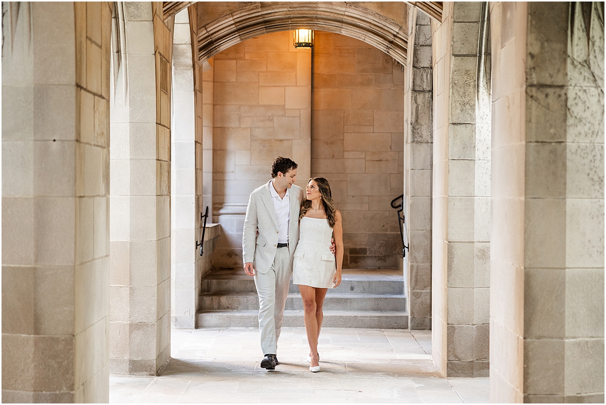 engaged couple walk through archways of Fourth Presbyterian Church 