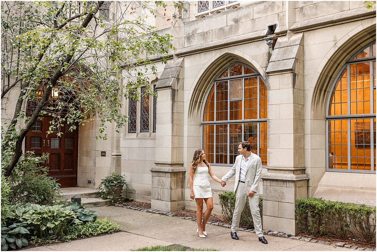 engaged couple walk outside of Fourth Presbyterian Church in downtown Chicago