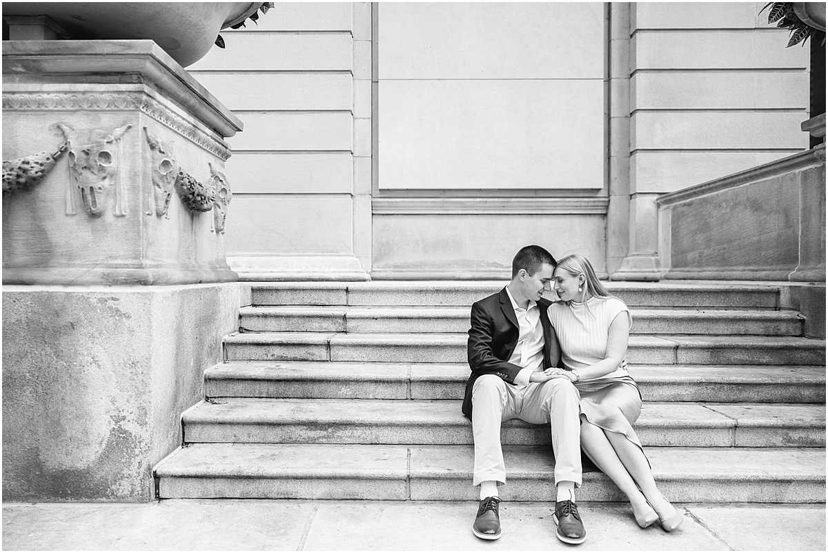 romantic engagement photos of couple sitting on stairs at Art Institute of Chicago