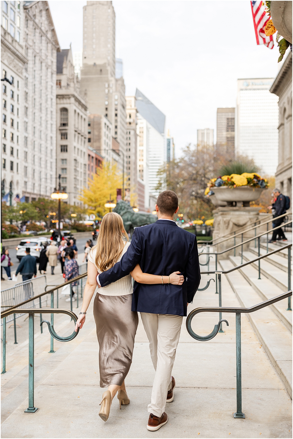 engaged couple walking outside of museum in Chicago 
