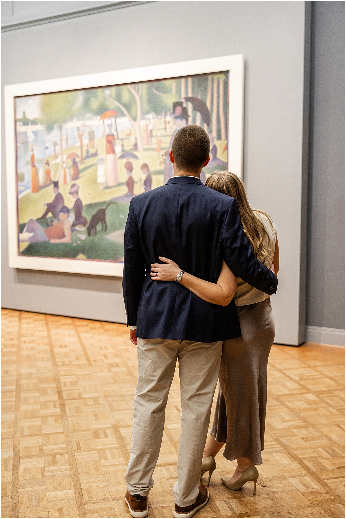 engaged couple admire artwork at museum in Chicago 