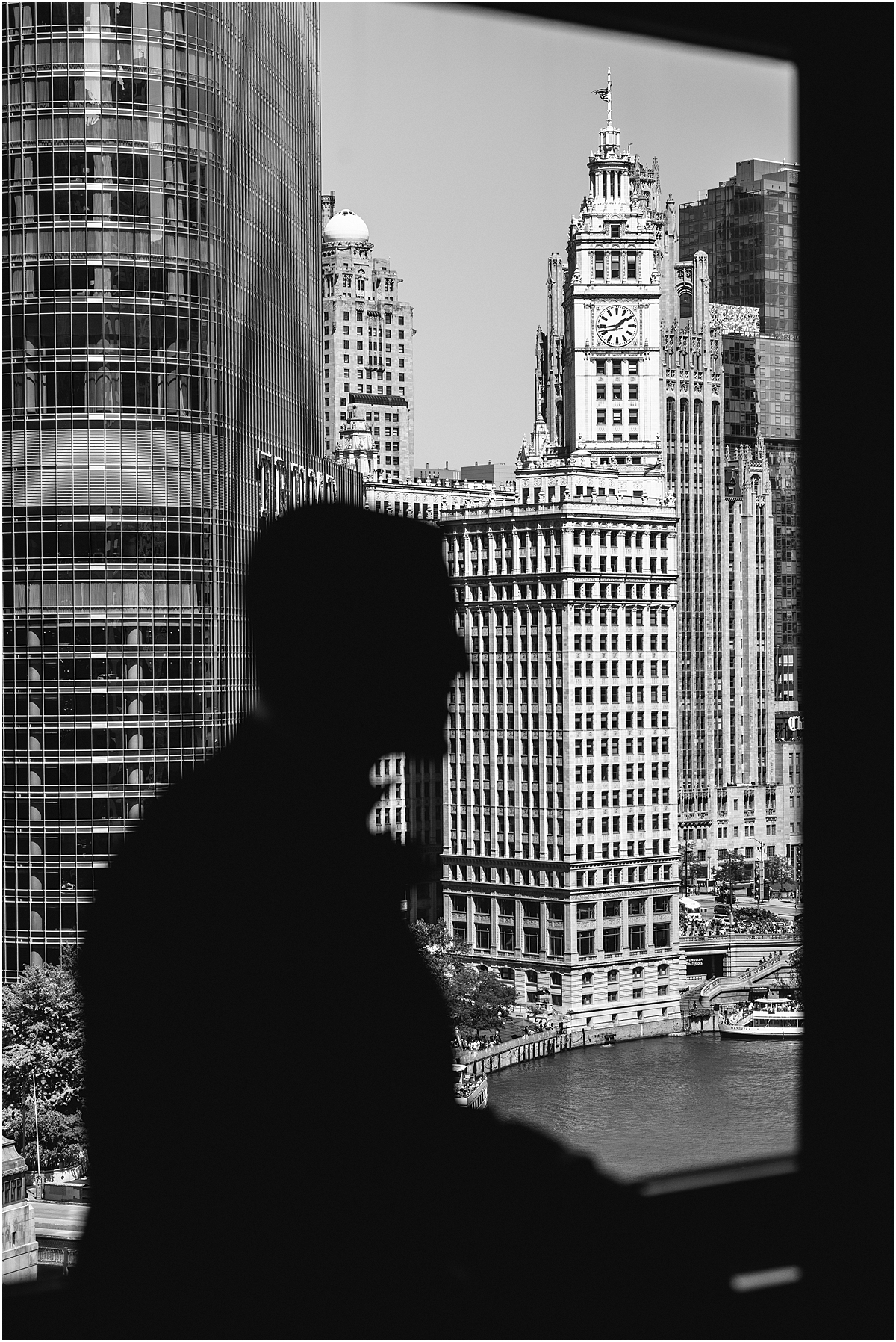 silhouette of groom with the Chicago city in the background through the window
