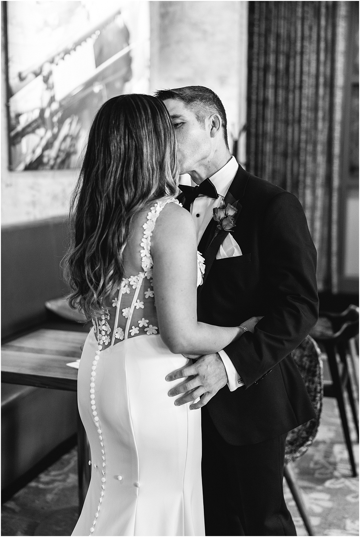 bride and groom kiss during first look