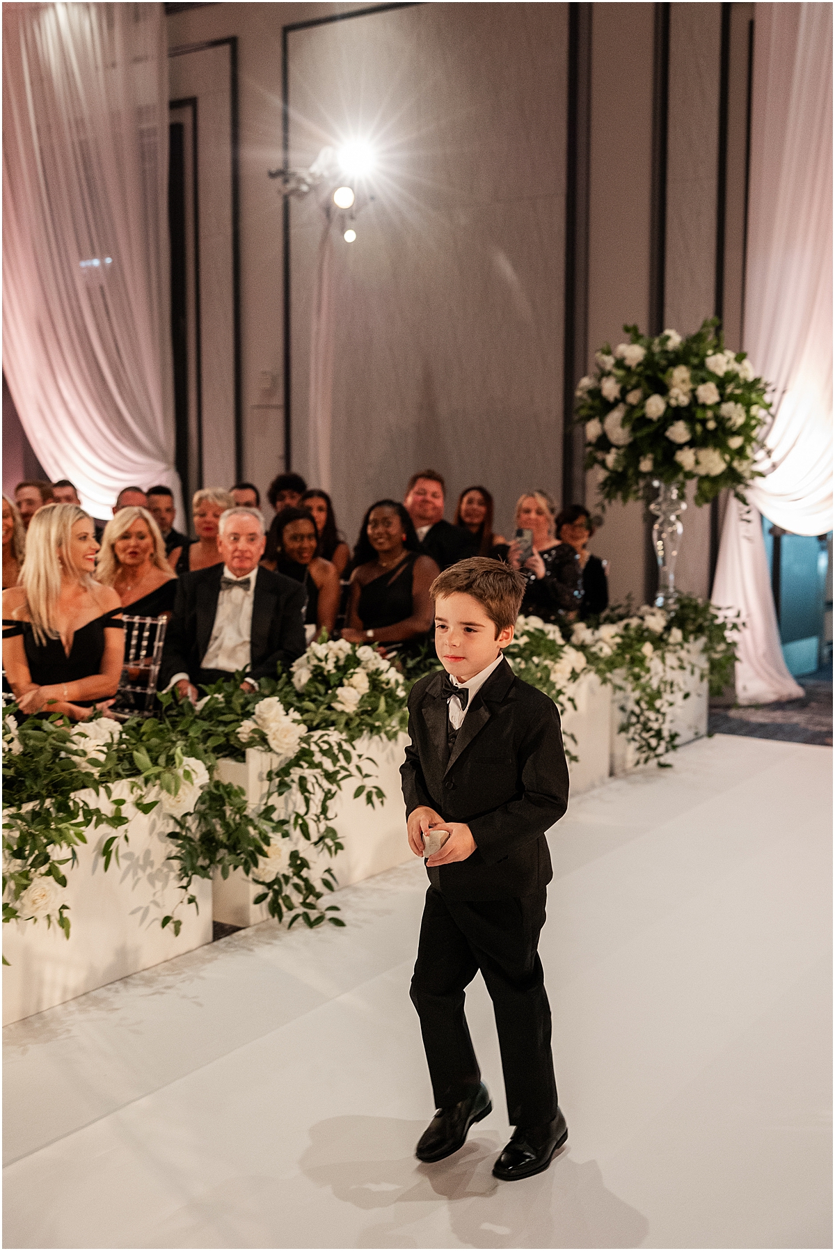 ring bearer walks down aisle 