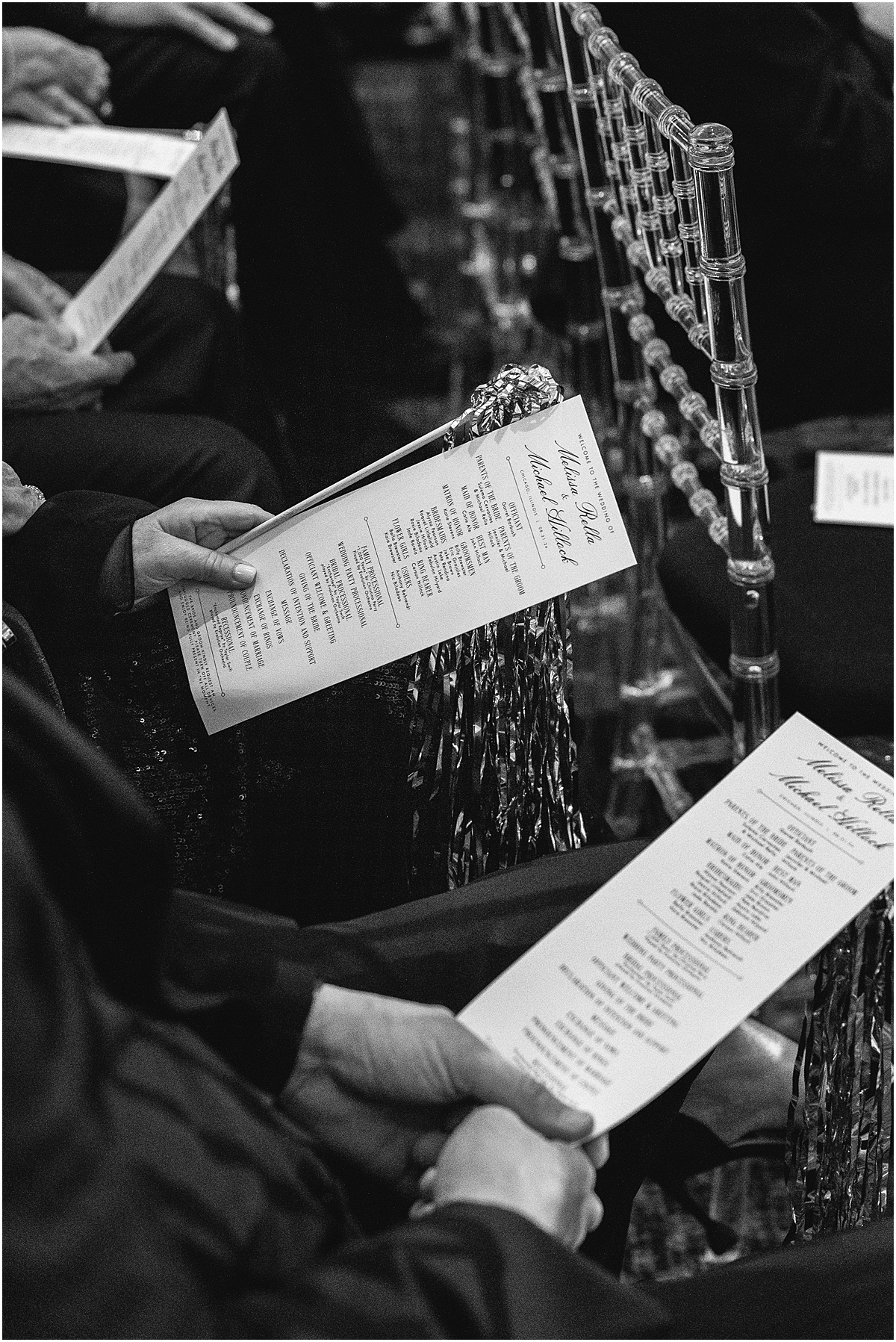guests holding wedding programs