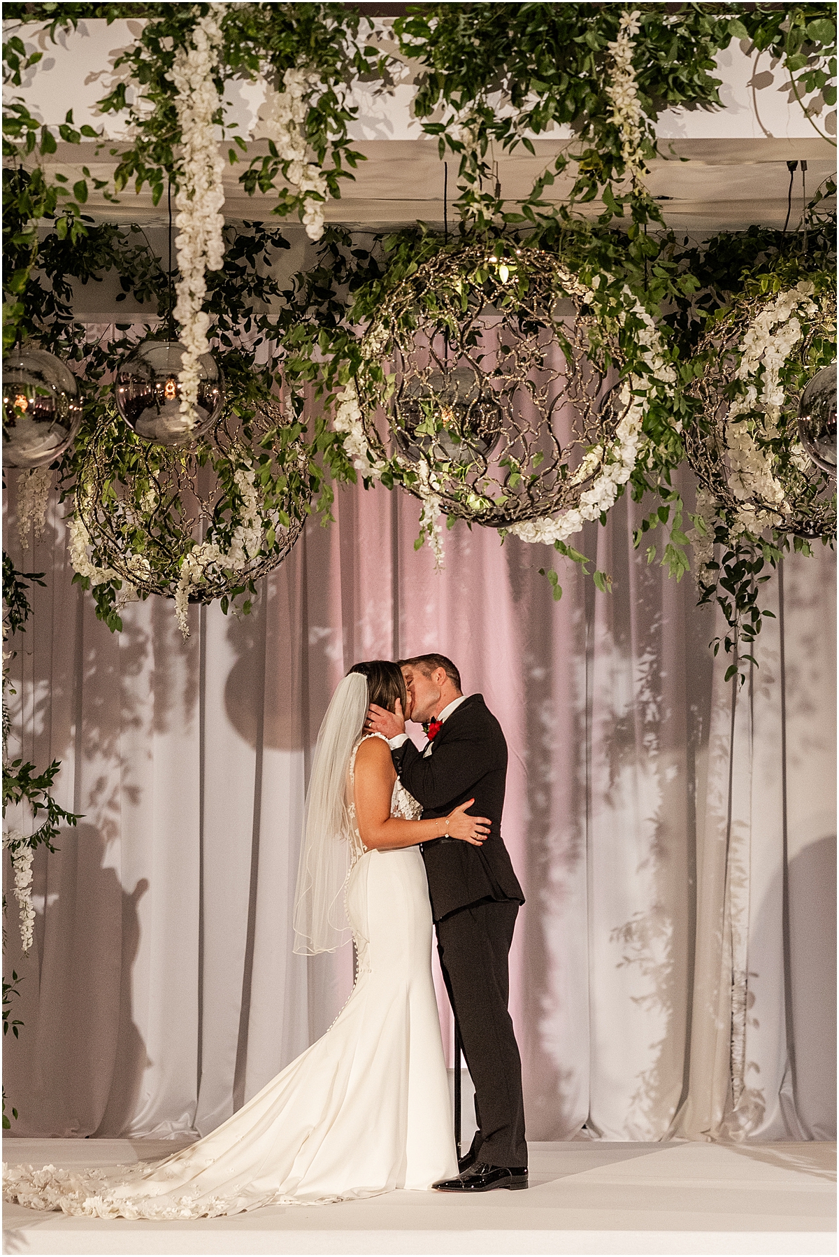 newlyweds kiss during wedding ceremony 
