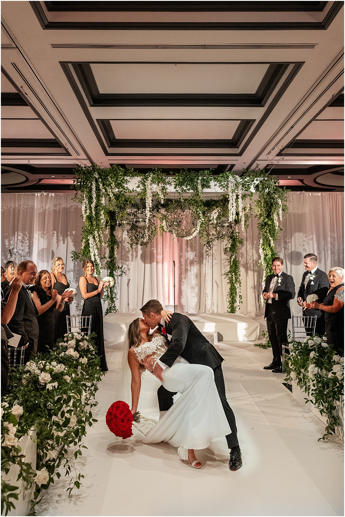 romantic dip kiss as newlyweds exit wedding ceremony