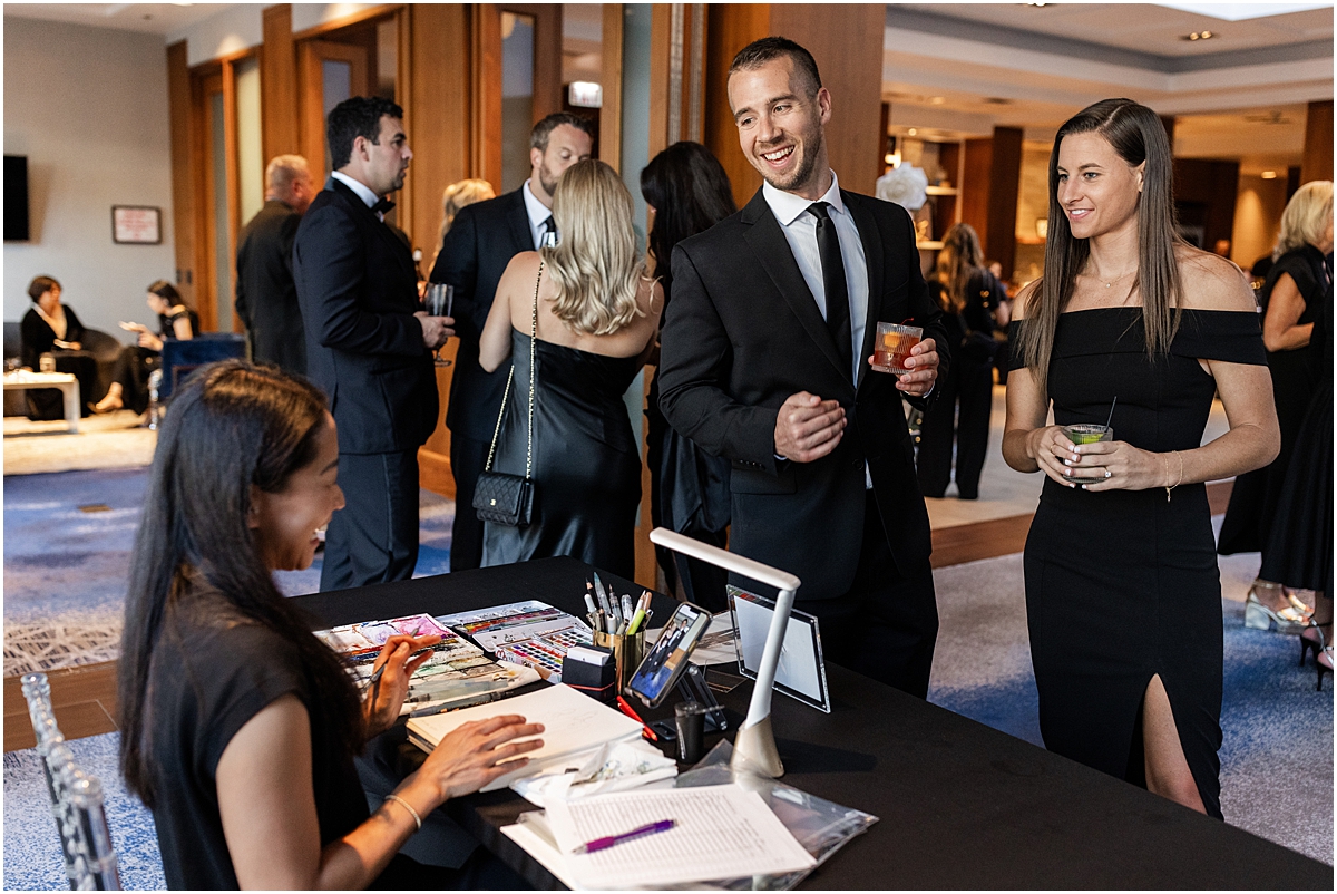 live artists paints guest portraits at Glamorous Chicago Renaissance Hotel Wedding