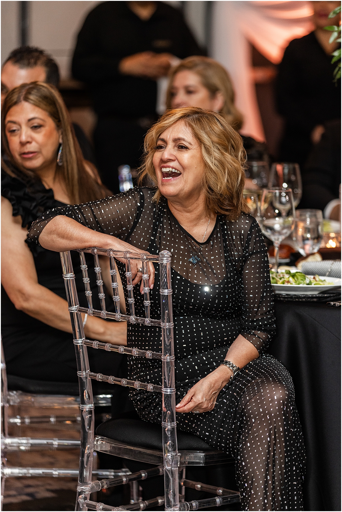 guests laugh during wedding speeches 