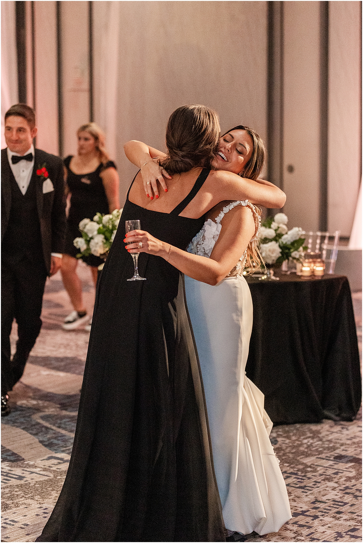 bride hugs bridesmaids 