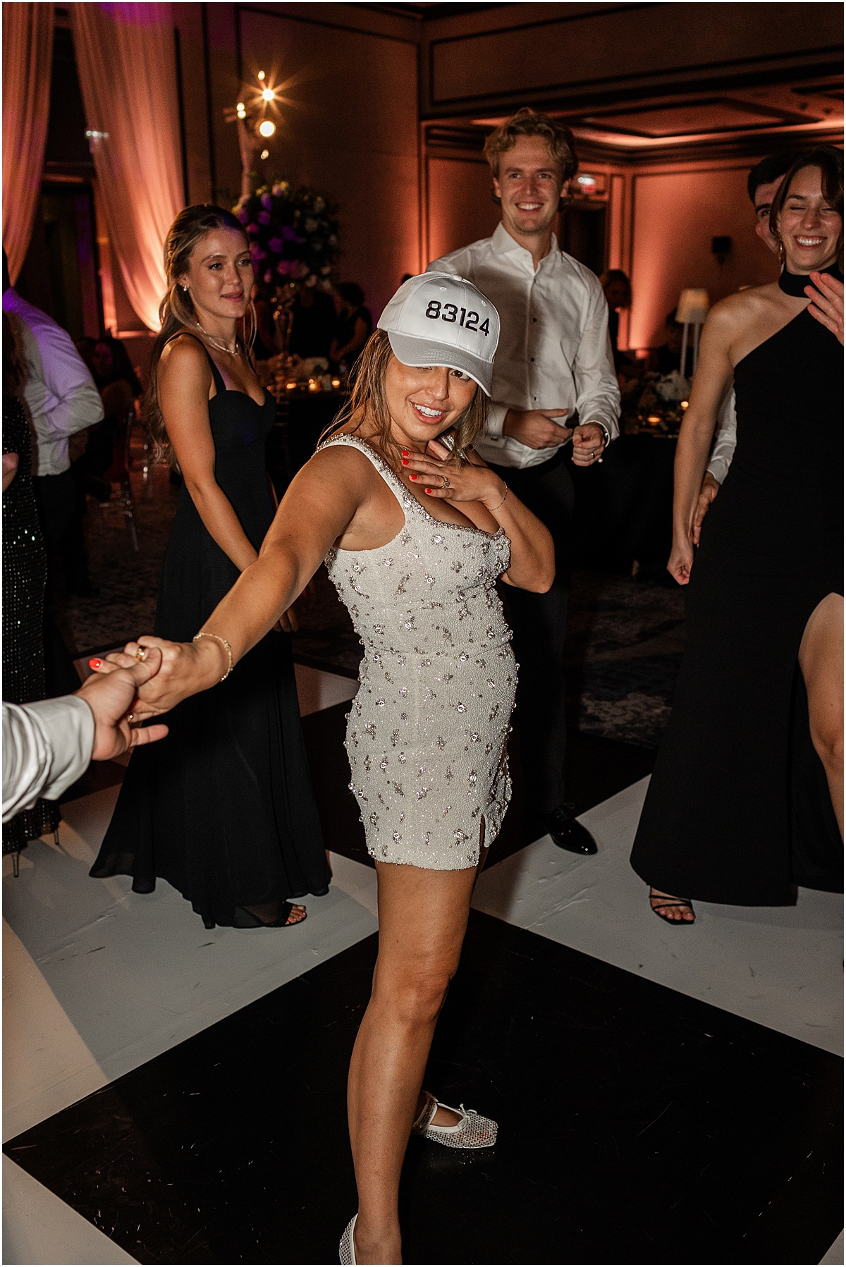Bride wearing custom hats with wedding date on them 